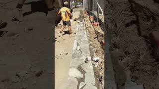 Sealing the top of this recycled concrete retaining wall with a dyed mortar shorts construction [upl. by Romito]