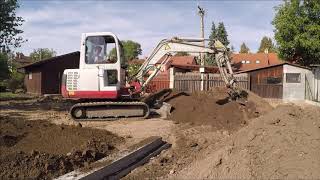 Takeuchi TB 135 leveling topsoil [upl. by Weasner]